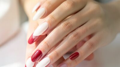 Cohesive manicure nail set in soft milky and cherry tones on elegant hands